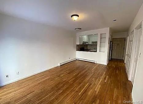 42-31 Colden Street, Unit R1A Queens, NY 11355 - Photo 4 of 9 a view of empty room with wooden floor