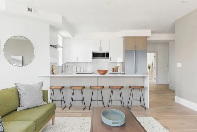 a living room with a couch and a a dining table
