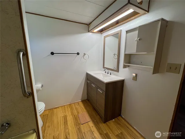 a bathroom with a sink a mirror and shower