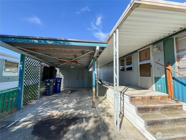 a view of a porch with a table and chairs
