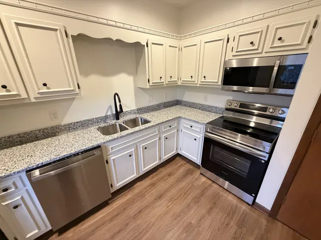 a kitchen with a refrigerator and a sink