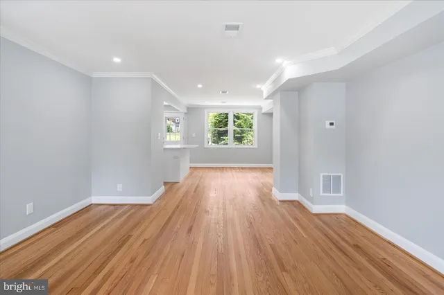 wooden floor in an empty room with a window