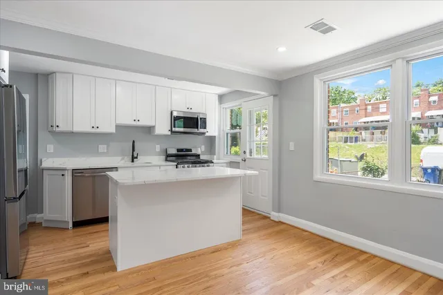 a kitchen with stainless steel appliances a sink stove and refrigerator