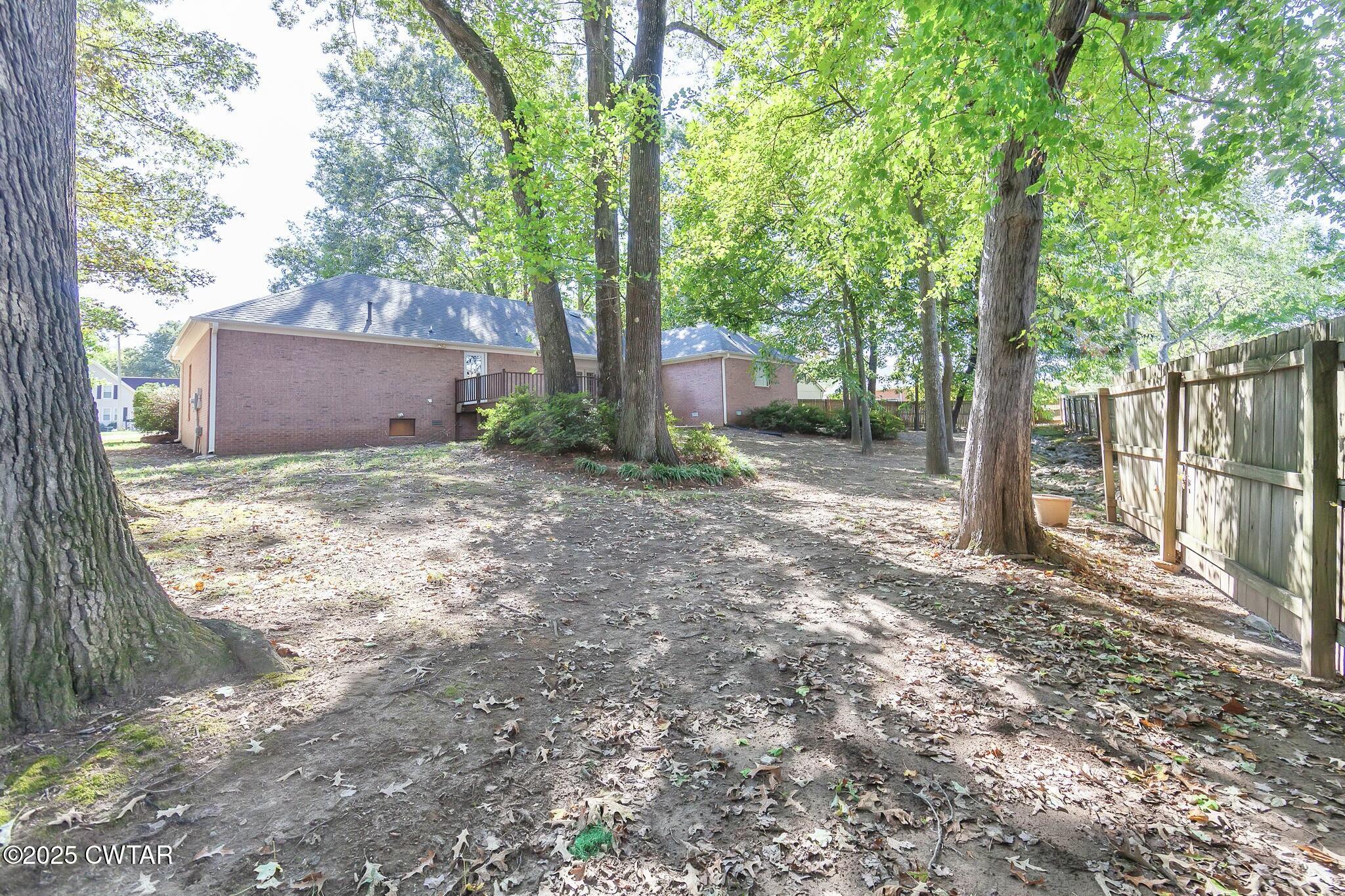 11 Deer Pointe Jackson, TN 38305 - Photo 27 of 30 a view of a house with large tree and wooden fence