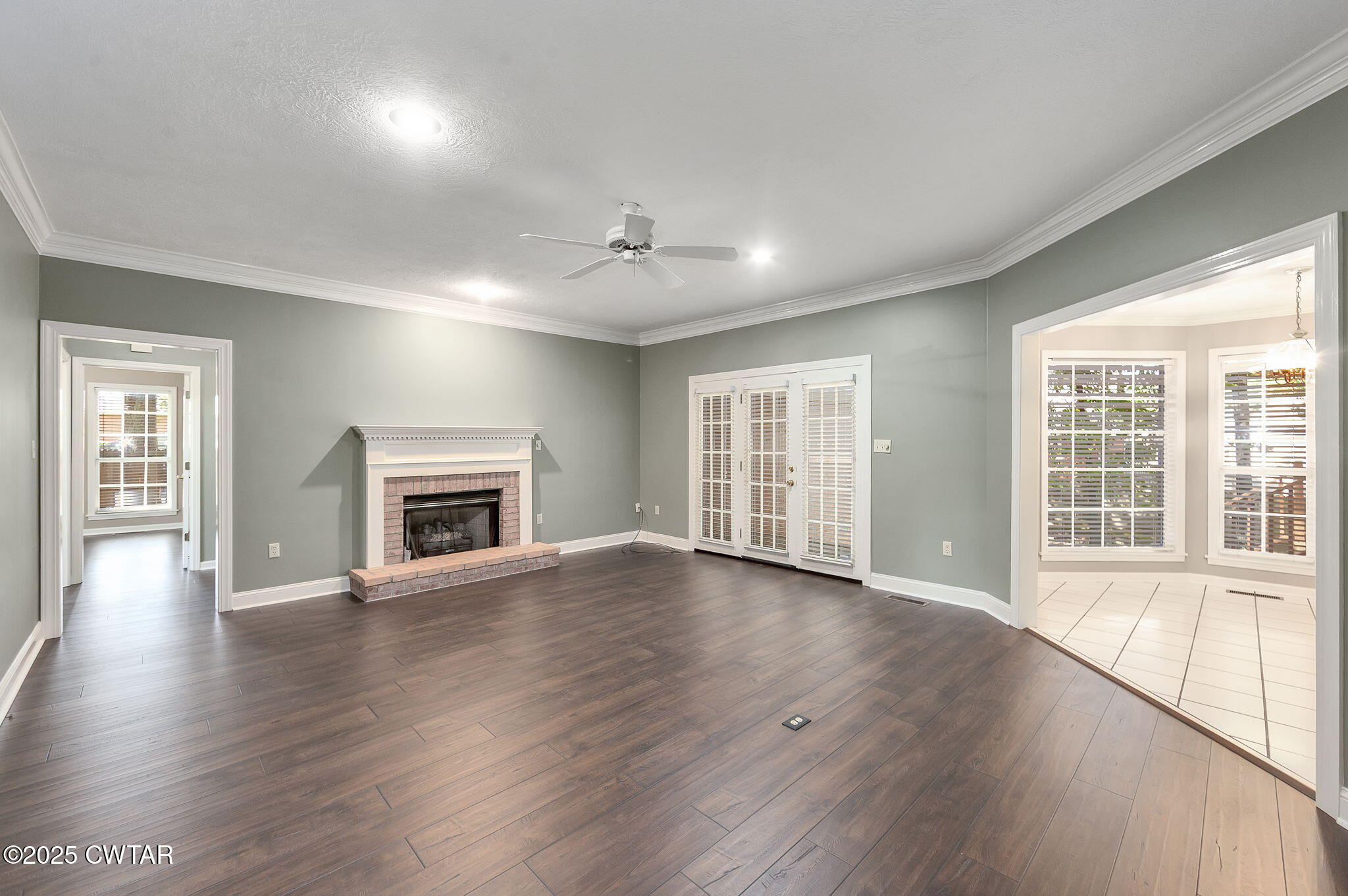 11 Deer Pointe Jackson, TN 38305 - Photo 3 of 30 an empty room with wooden floor fireplace and windows