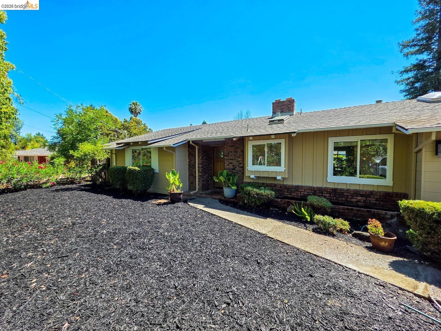 965 Springer Road Los Altos, CA 94024 - Photo 1 of 31 Ranch-style exterior with a tan facade and brick accents