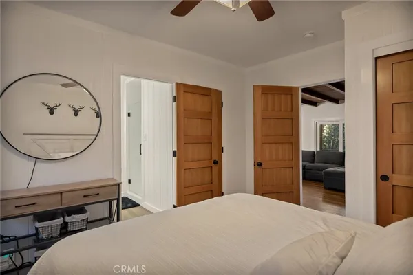 a bedroom with a bed a mirror and a desk