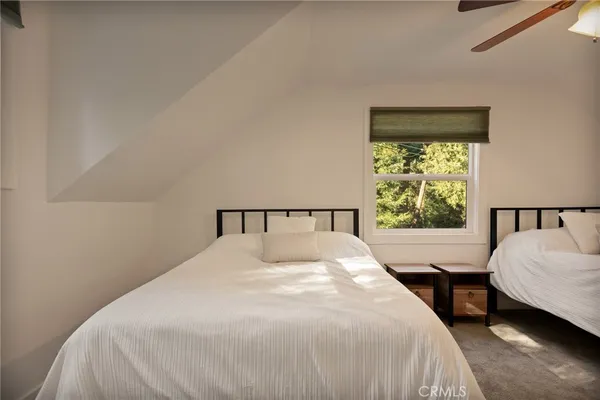 a bedroom with a large bed and a window