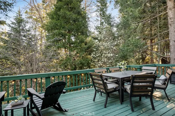 a view of a deck with table and chairs and wooden floor