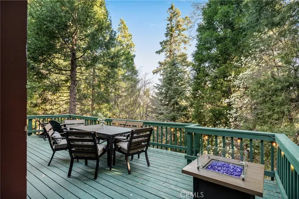 a view of a wooden chairs and table on the deck