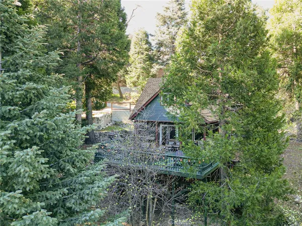 an aerial view of house with yard and outdoor seating