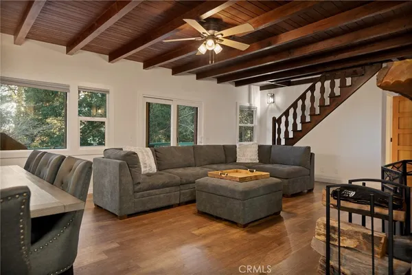 a living room with furniture fireplace and a table