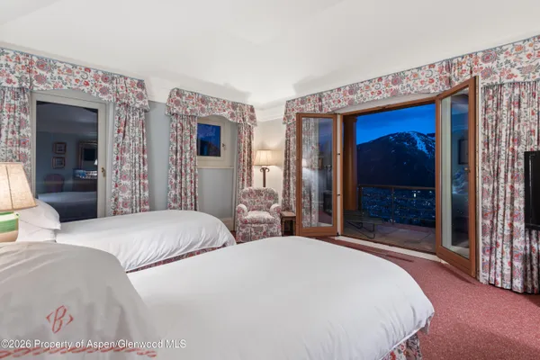a bedroom with bed and a large mirror
