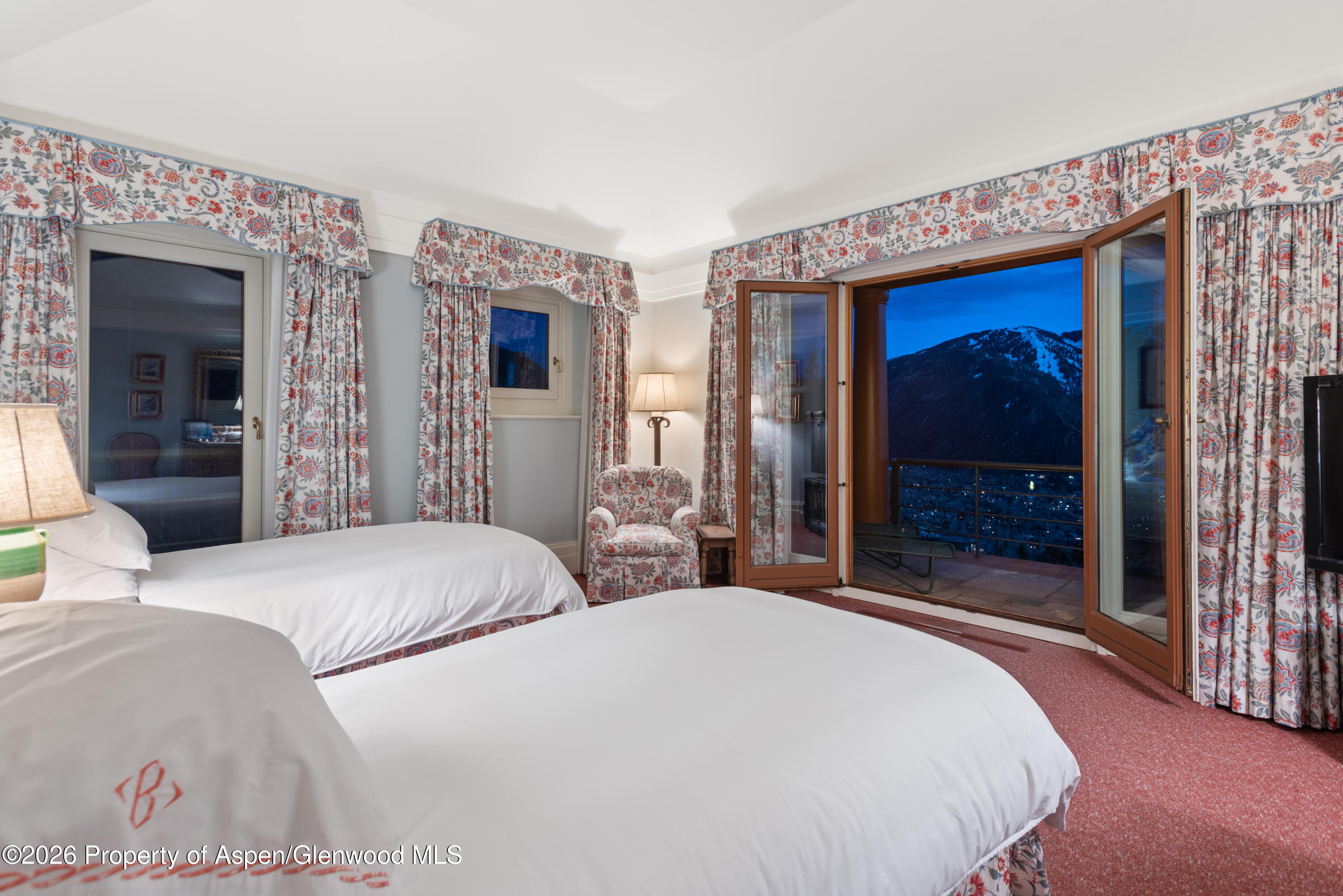 2131 Red Mountain Road Aspen, CO 81612 - Photo 19 of 31 a bedroom with bed and a large mirror