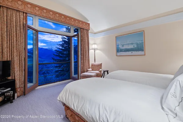 a bedroom with a bed and a mirror