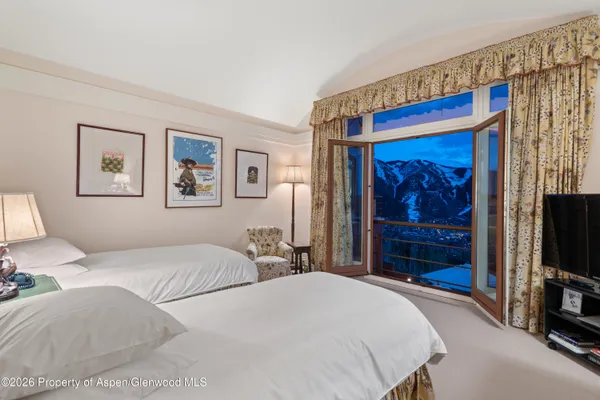a bedroom with a bed and a television