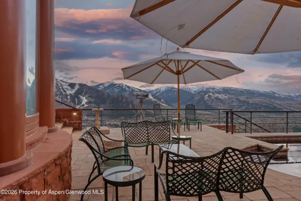 a patio with a patio table and chairs