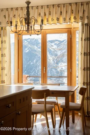 a view of a front door with a table and chairs