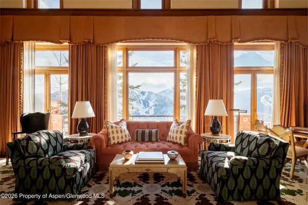 a living room with furniture and large windows