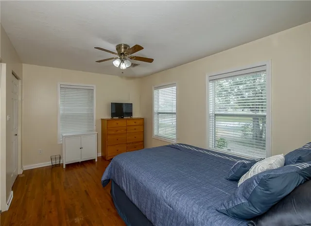 a bedroom with a bed and a television