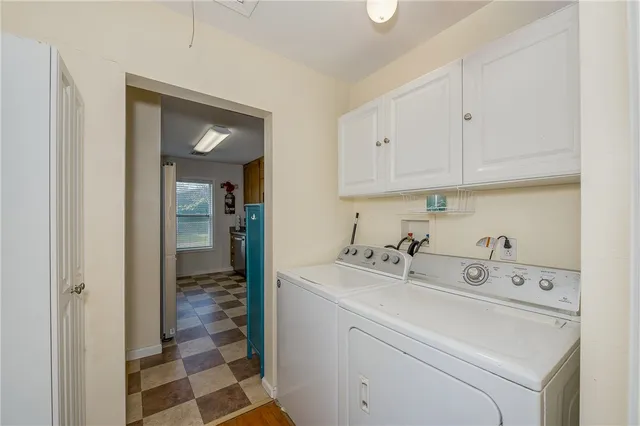 a utility room with closet dryer and washer