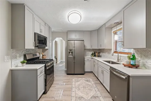 a kitchen with a sink stove and refrigerator