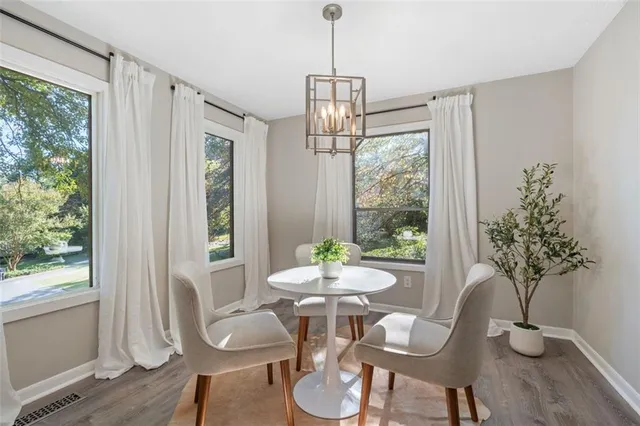 a dining room with furniture window and wooden floor