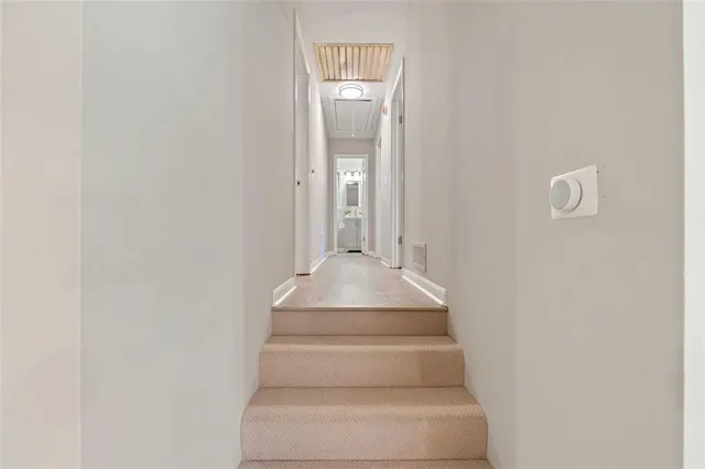 a view of staircase with white walls