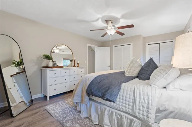 a bedroom with a large bed and a chandelier