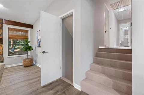 a view of an entryway with wooden floor and windows