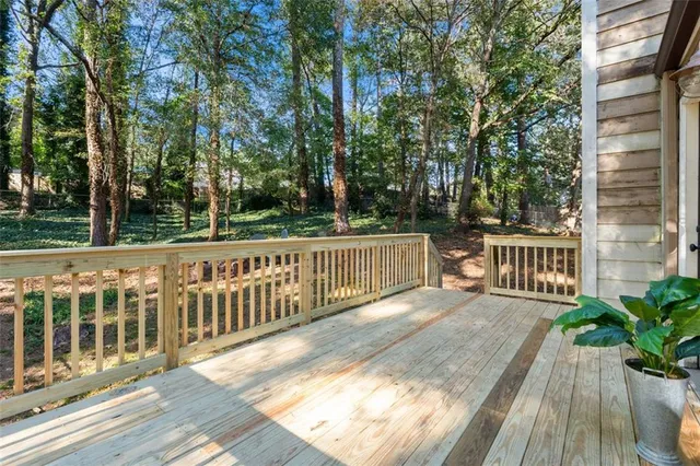 a view of a house with backyard and deck