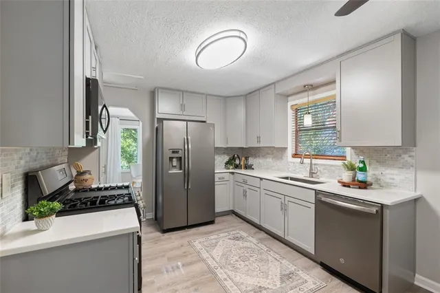 a kitchen with a sink appliances and cabinets