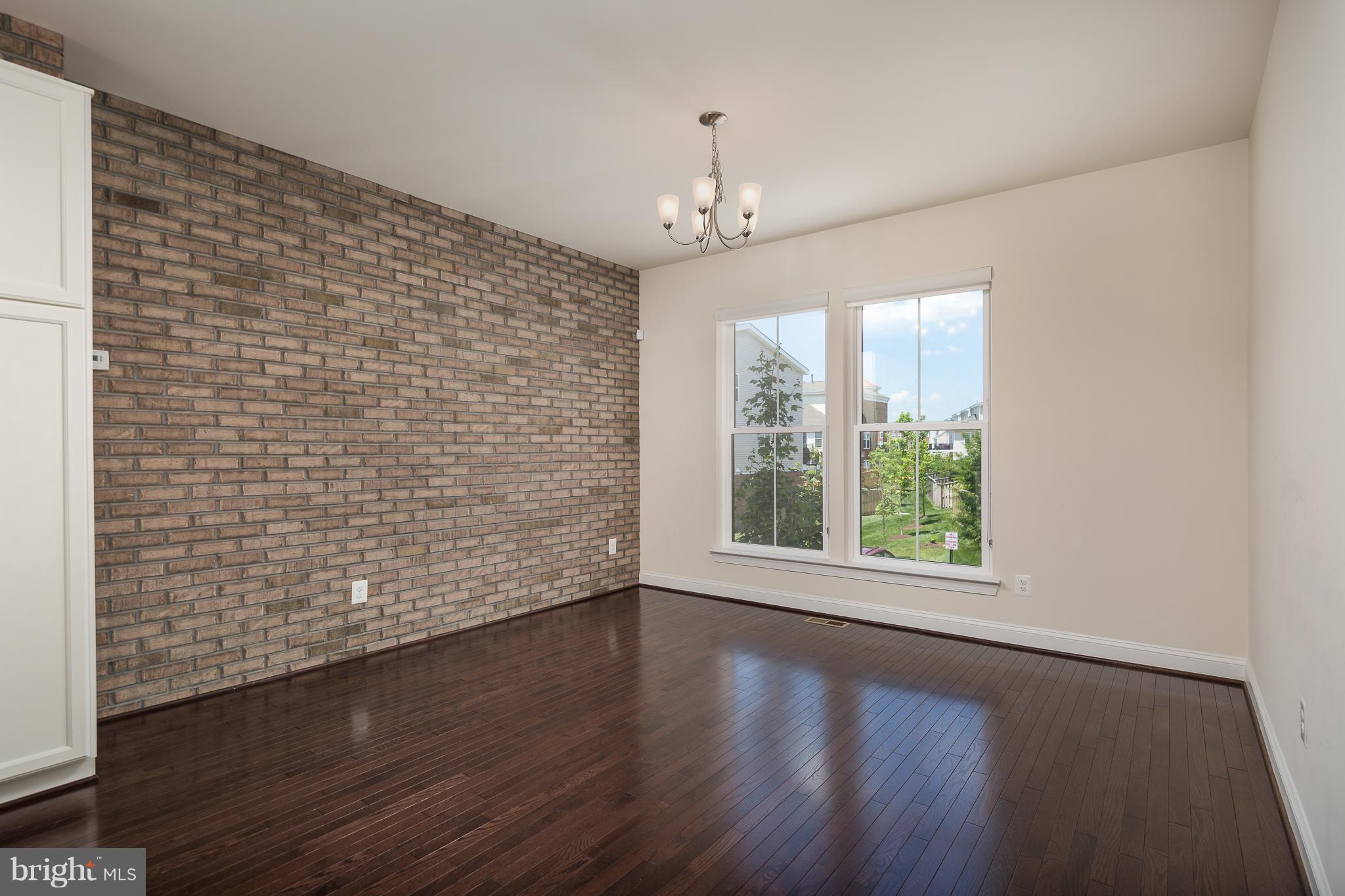 42287 Riggins Ridge Terrace Ashburn, VA 20148 - Photo 6 of 27 Dining Room-BRICK ACCENT WALL