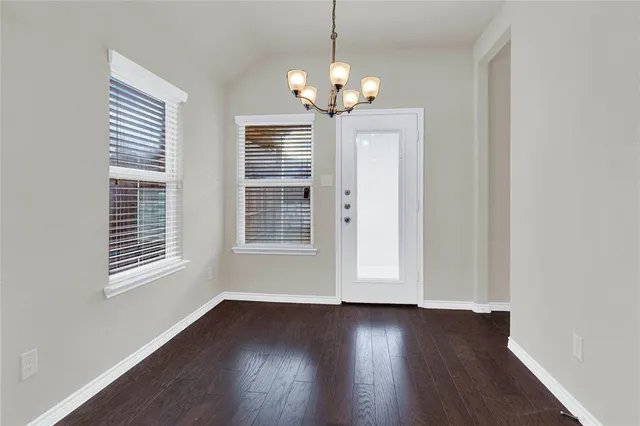 a view of wooden floor and windows in a room