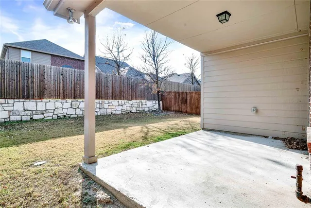 a view of a backyard with wooden fence