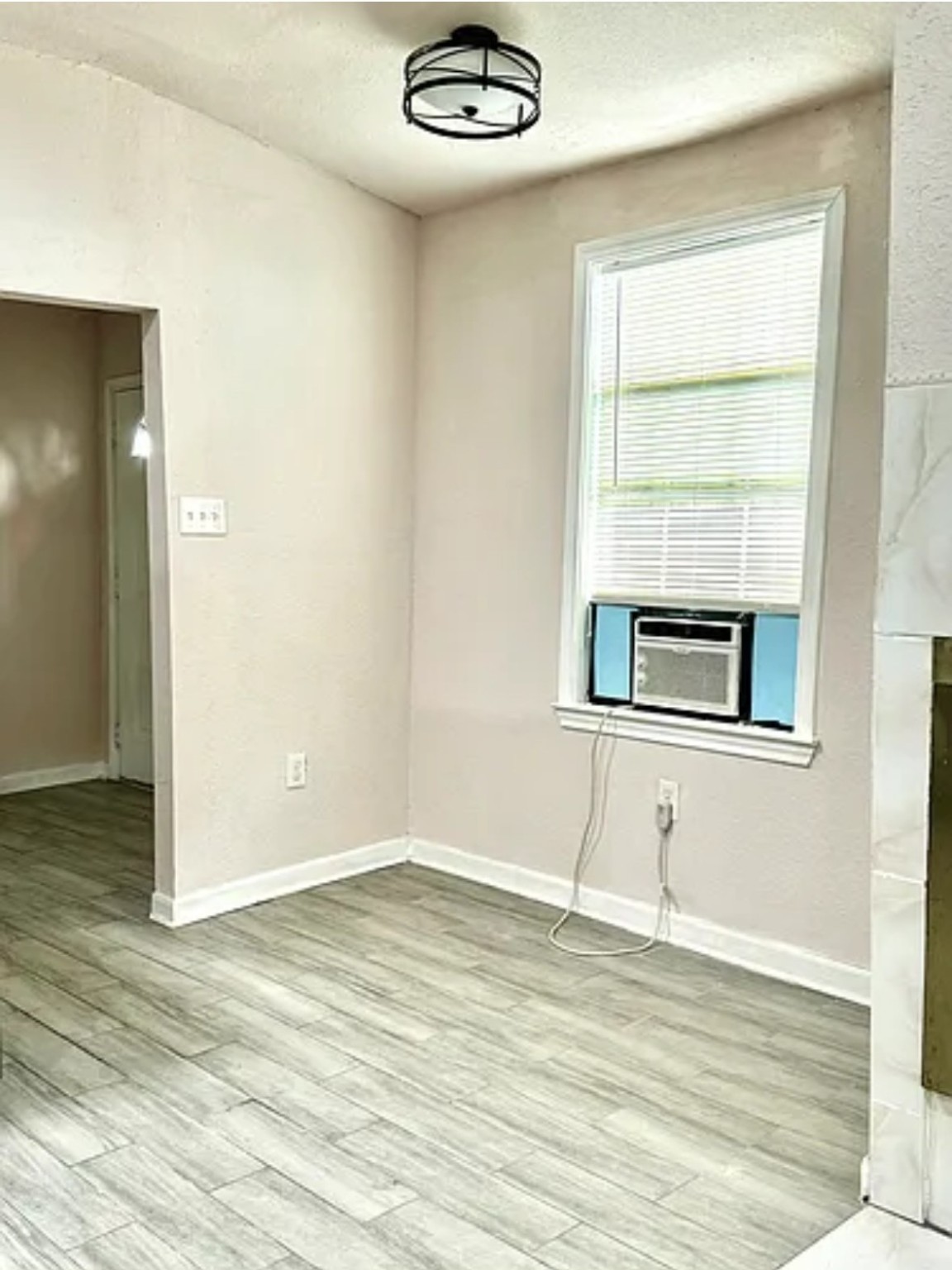 7339 Mountbatten Road Houston, TX 77033 - Photo 13 of 33 an empty room with wooden floor cabinet and windows
