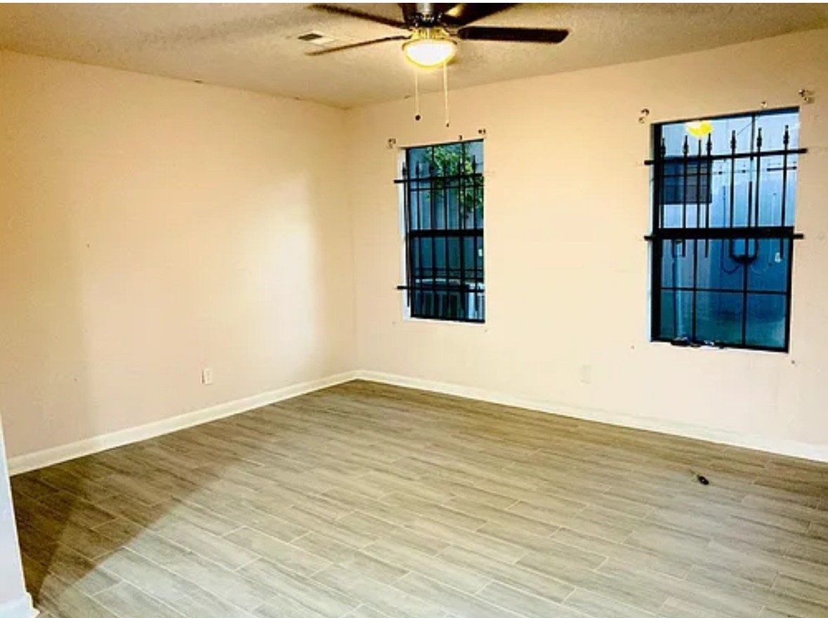 7339 Mountbatten Road Houston, TX 77033 - Photo 16 of 33 a view of an empty room with wooden floor