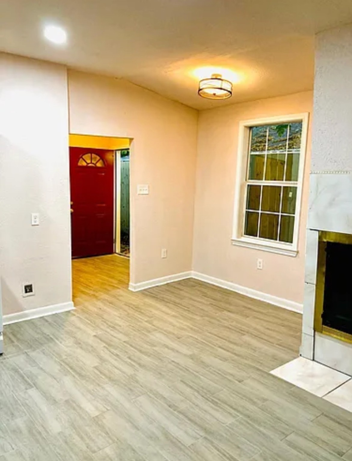 7339 Mountbatten Road Houston, TX 77033 - Photo 5 of 33 a view of an empty room with wooden floor and a window