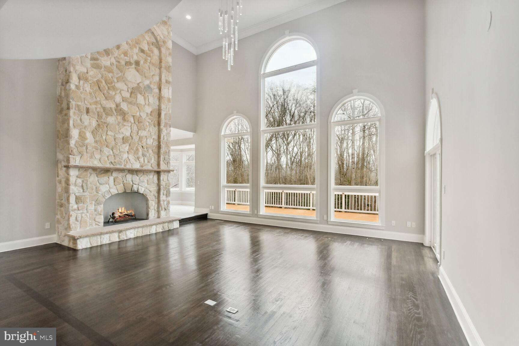 209 River Bend Road Great Falls, VA 22066 - Photo 12 of 44 a view of an empty room with wooden floor and a window