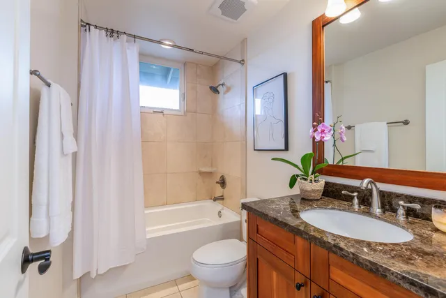 an aerial view of residential houses with outdoor space and trees