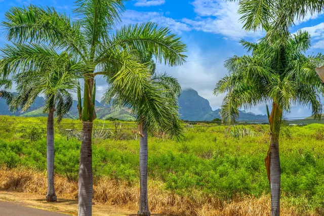 a view of a house with a yard and sitting area