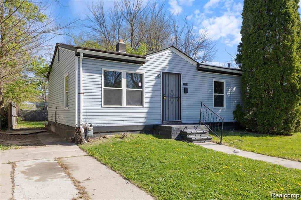 26076 Colgate Street Inkster, MI 48141 - Photo 2 of 24 Light blue siding exterior with a dark gray front door and security screen