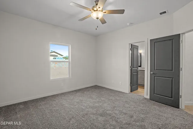 an empty room with windows and closet