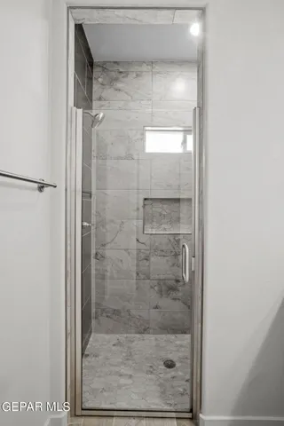 a bathroom with a glass door shower