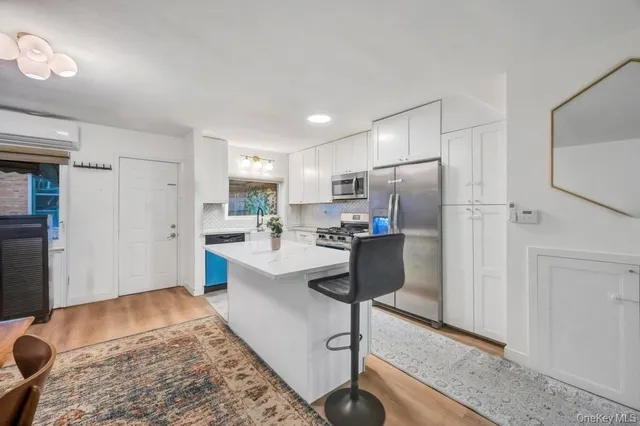 a kitchen with stainless steel appliances kitchen island granite countertop refrigerator sink and cabinets