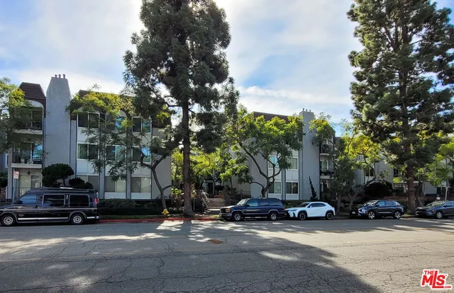 a view of a parked cars in front of a building