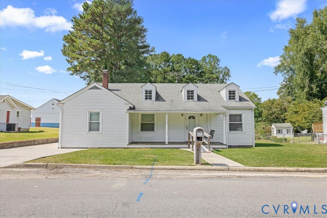 106 Sylvan Road Wakefield, VA 23888 - Photo 1 of 29 New england style home featuring a porch, a chimne