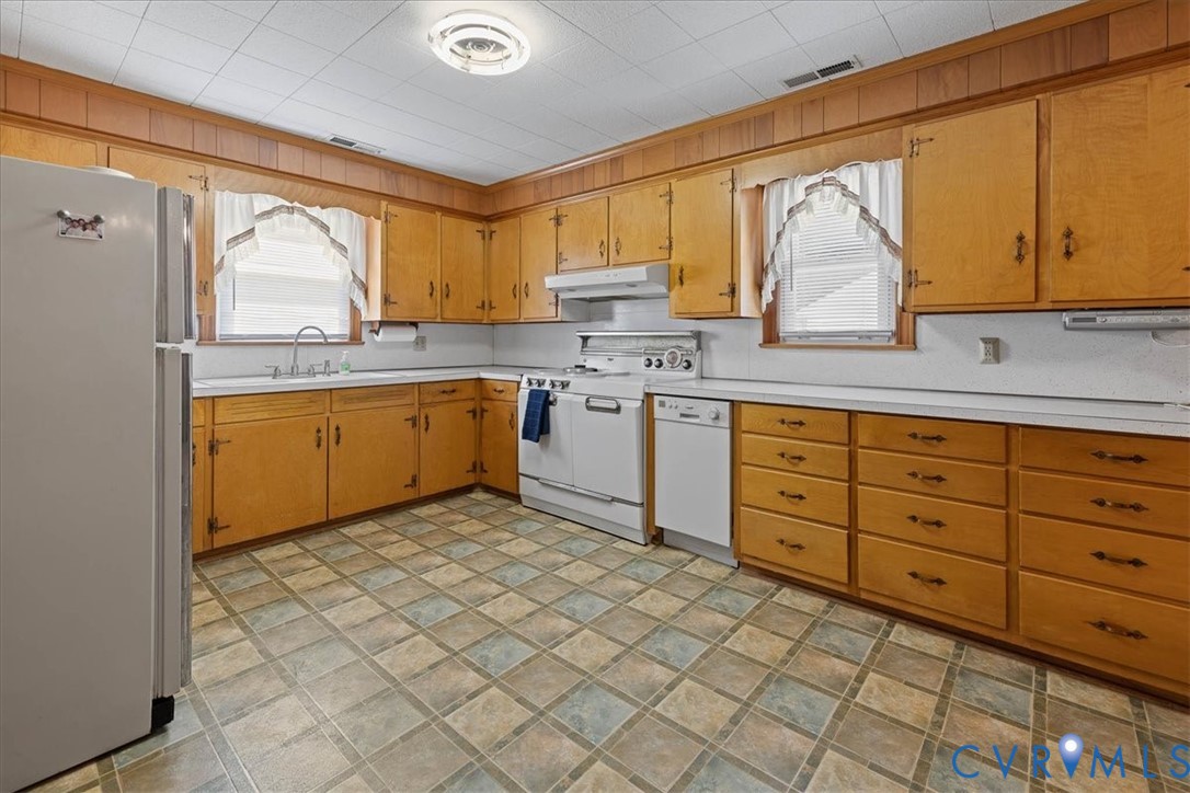 106 Sylvan Road Wakefield, VA 23888 - Photo 13 of 29 Kitchen with white appliances, light countertops,