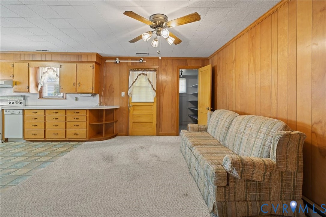 106 Sylvan Road Wakefield, VA 23888 - Photo 8 of 29 Kitchen featuring light countertops, wood walls, w