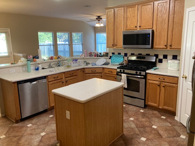 4816 Norman Trail Austin, TX 78749 - Photo 6 of 19 a kitchen with stainless steel appliances stove microwave sink and cabinets